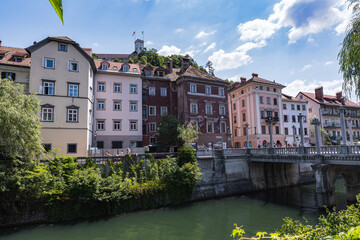 Ljubljana river banks with colourful buildings and the castle dominating the city. Slovenia
