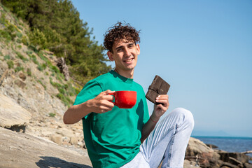 A young attractive guy is resting by the sea.