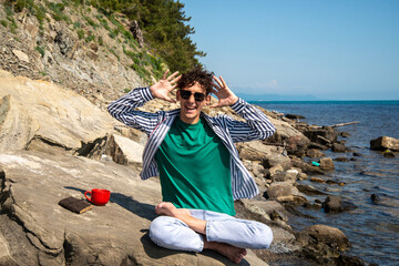 A young attractive guy is resting by the sea.