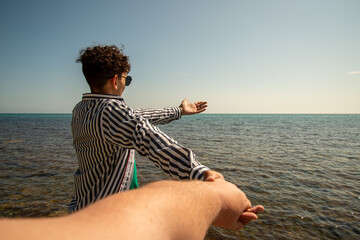 Love and romance. Two guys are walking along the beach.