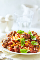 Spaghetti Pasta with Meatballs and fresh Basil o bright background. Close up.