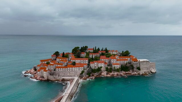 Sveti Stefan is an amazing island resort in Montenegro on the Adriatic coast, with white beaches, luxury hotels and picturesque streets. One of the most romantic places in Montenegro. 4k drone video.