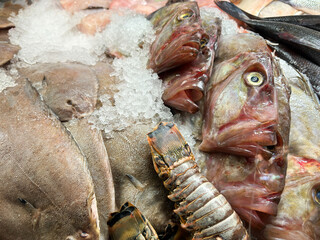 Fresh John Dory fish on ice on a fishmonger's market stall