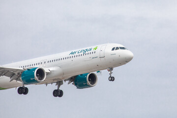 Fototapeta premium Toronto, Canada, April 4, 2022; Nose and engine view of an Irish Air Lingus Airbus A-321 neo landing at Toronto Pearson Airport YYZ from Ireland, pointing right