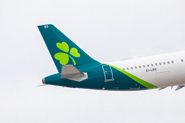 Obraz premium Toronto, Canada, April 4, 2022; The tail plane Irish Shamrock logo of an Irish Air Lingus Airbus A-321 neo landing at Toronto Pearson Airport YYZ from Ireland, pointing right