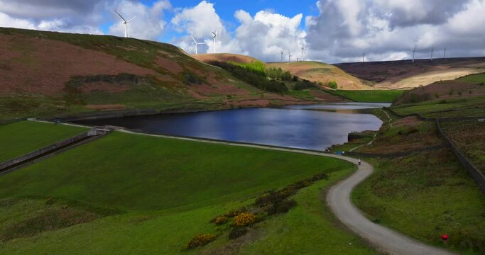 Aerial image of Naden valley middle reservoir and wind turbines at the top of the hills in Rochdale, Greater Manchester