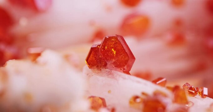 orange Vanadinite crystals with mooving light, from morocco. macro photography detail texture background. close-up raw rough unpolished semi-precious gemstone 