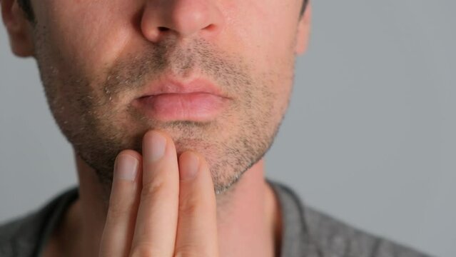 Close-up of a man with stubble in the bathroom before shaving.