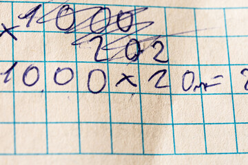 Solving multiplication examples written onm the paper. Correcting mistakes in the calculations.