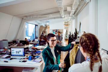 Two fashion designers working together on a project in a design studio