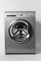 A silver washing machine placed on a counter. Suitable for household appliance concepts