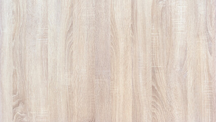A wooden surface with a grainy texture. The surface is white and has a natural look. The wood grain is visible and adds character to the surface