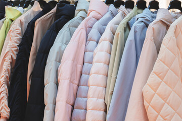 A rack of jackets with a mix of colors and styles