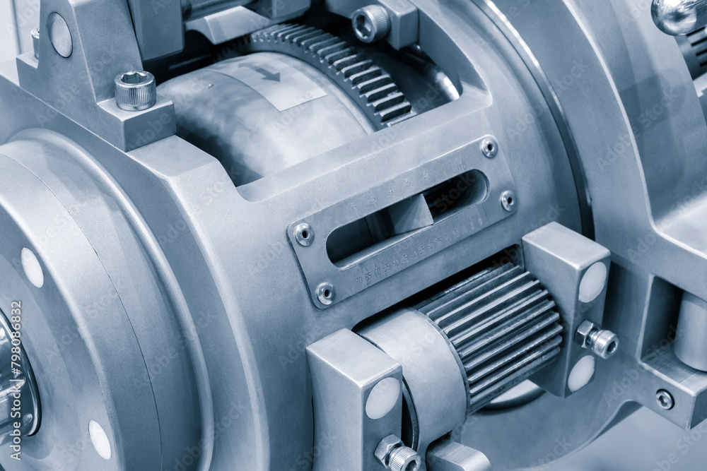 Poster a machine with a blue and silver color. the machine has a lot of gears and is made of metal
