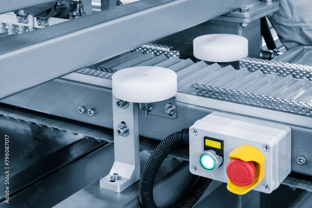 Poster a machine with a red button and a green light, industrial concept background