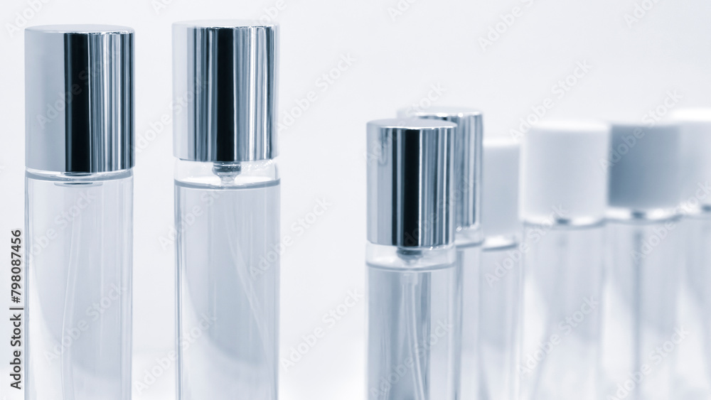 Poster a row of clear bottles with silver tops. the bottles are lined up next to each other. the bottles ar