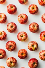 Fresh apples arranged in a neat pattern on a white backdrop, showcasing concepts of health, repetition, and natural simplicity