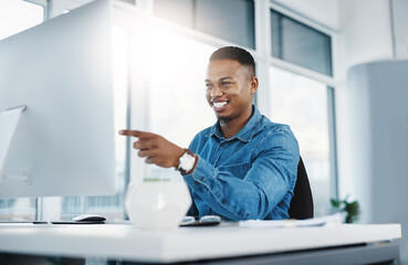 Happy, pointing and black man by computer in office, workspace and desk confident in creative...