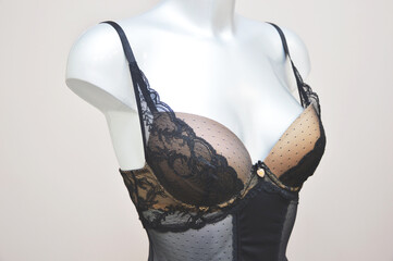 Lace black combodress bra, grace, body corset on a mannequin in a store. Lingerie.
