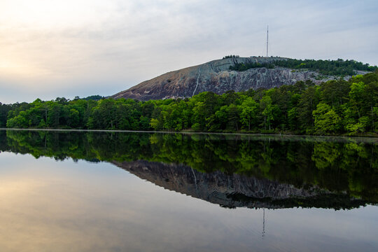 reflection of trees and mountain in lake water in Stone Mountain Park Atlanta