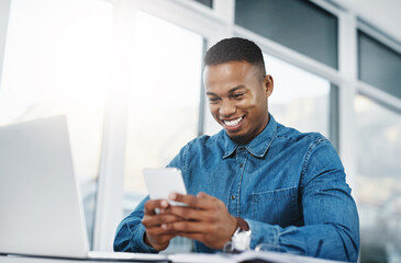 Smile, cellphone and black man by computer in office, workspace and desk happy in creative career. Communication, internship and journalist with tech for contact, research and internet for working