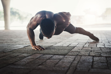 Black man, push up and strong with fitness in city for balance, shirtless or muscle for power on...