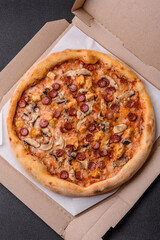 Delicious pizza with sausage, cheese, tomatoes, salt, spices and herbs
