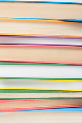 Book stacking. Open book, hardback books on wooden table and blue background. Back to school. Copy space for text.