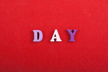 DAY word on red background composed from colorful abc alphabet block wooden letters, copy space for ad text. Learning english concept. - 798134407