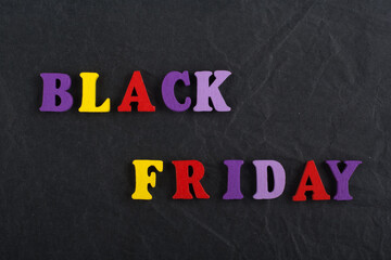 BLACK FRIDAY word on black board background composed from colorful abc alphabet block wooden letters, copy space for ad text. Learning english concept. - 798134425