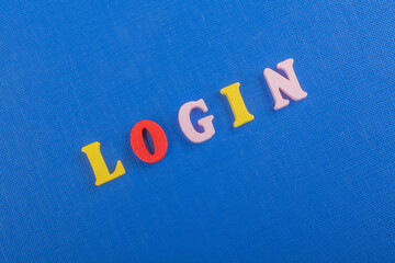 LOGIN word on blue background composed from colorful abc alphabet block wooden letters, copy space for ad text. Learning english concept. - 798134670