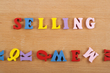 SELLING word on wooden background composed from colorful abc alphabet block wooden letters, copy space for ad text. Learning english concept. - 798134855