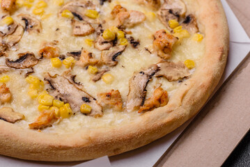 Delicious pizza with corn, cheese, tomatoes and mushrooms, salt, spices and herbs
