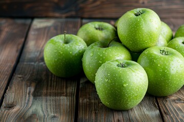 A pile of green apples on a wooden table