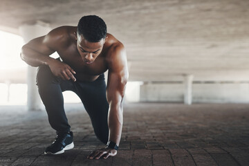 Black man, athlete and outdoor or start exercise with muscle in parking garage for cardio, fitness or strength. Male person, ground and shirtless for summer run is sportswear, wellness or training