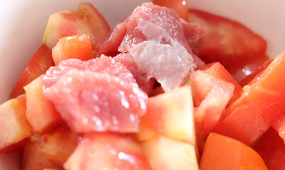 chopped tomatoes with meat. red meat with tomato. preparing lunch with meat and tomatoes.