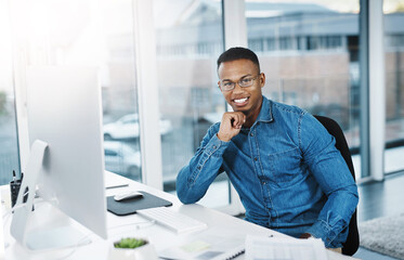 Portrait, smile and businessman in modern office with laptop, paperwork and happy at desk. Black...