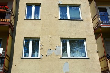 70s apartment block with paint peeling off the wall