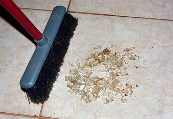 A swept broken glass on the floor