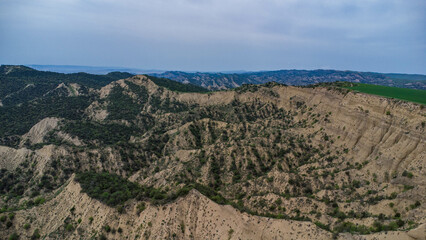 car are move in field near the canyon