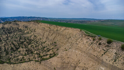 car are move in field near the canyon