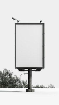 b'Blank billboard on the side of the road with trees and a street lamp in the background'