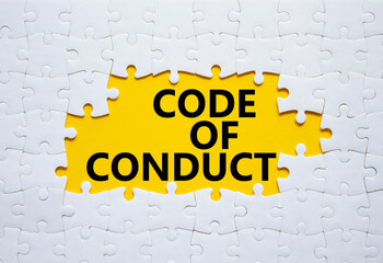 Code of conduct symbol. White Puzzle with words Code of conduct. Beautiful yellow background....