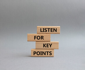 Key points symbol. Wooden blocks with words Listen for Key points. Beautiful grey background....