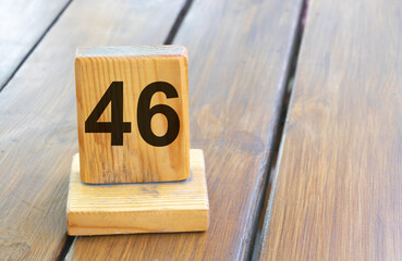 Wooden priority number 46 on a plank tab