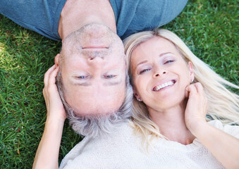 Mature, couple and portrait in grass park as top view for vacation travel in summer, anniversary or marriage. Man, woman and face from above on field in New Zealand or home backyard, love or date