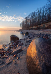 rocky shore of the Baltic sea at dawn, stones in the foreground