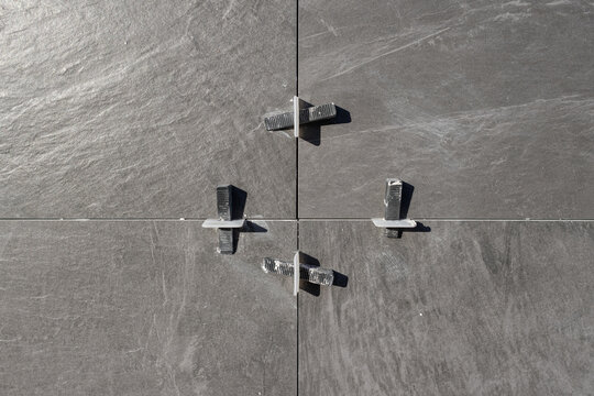 Installed Ceramic tiles with Plastic tile leveling system clips and wedges on construction site