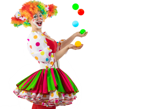 Funny juggler female clown juggling balls in the circus, woman entertainer as Joker in suit and wig, with clown whiteface makeup. Trickster, jester, pantomime, mime, and a professional actor at events