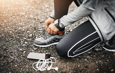 Person, smartphone and shoelace with running or workout for fitness, health and wellbeing in...